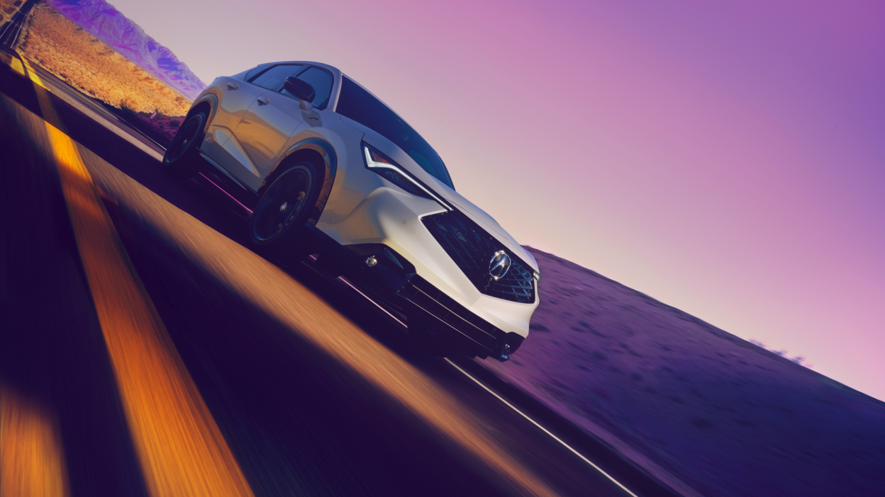 Angled image of a grey Acura ADX on a highway. 