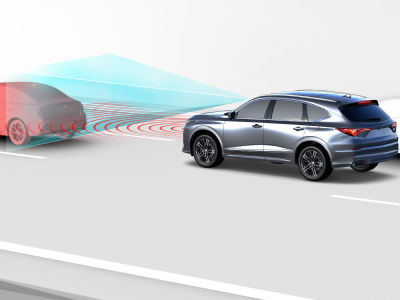 Digital rendering, where everything is white except for the MDX. 3/4 side rear view of grey MDX driving on road. Blue sensor lines and red waves emitting from the front of the MDX detect the car in front.